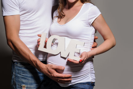 Pregnant Couple holding word Loveの写真素材
