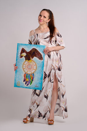 artist with own picture over grey backgroundの写真素材