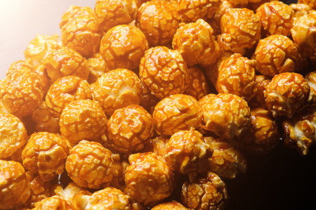 sweet Caramel Cream popcorn on the black background. Close-up picture, macro detailsの写真素材