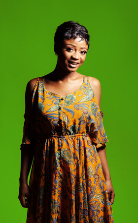 Portrait of a beautiful young African woman over yellow background. Studio pictureの写真素材