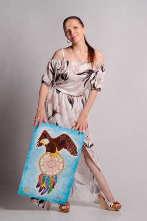 artist with own picture over grey backgroundの写真素材