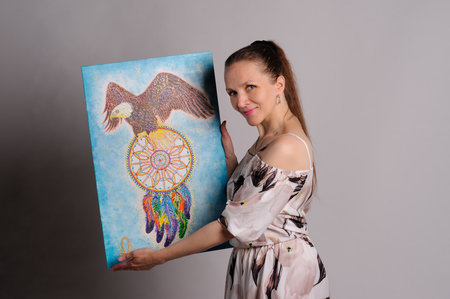 artist with own picture over grey backgroundの写真素材