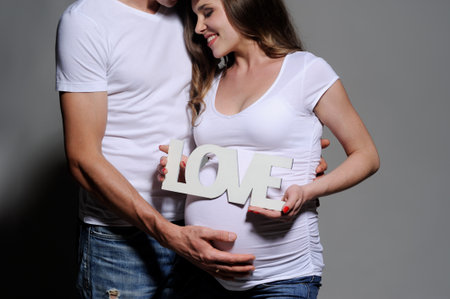Pregnant Couple holding word Loveの写真素材