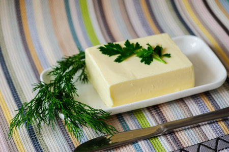 piece of butter with knife on a deskの写真素材