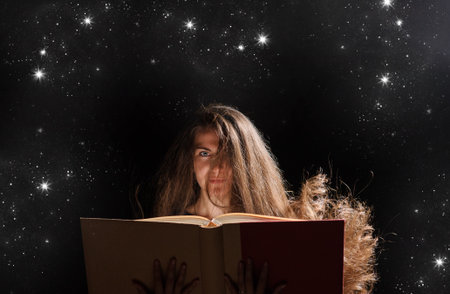 Magic Woman reading a book. black backgroundの写真素材