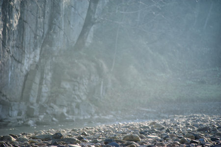 Rocky coast of the river. Landscape of countryside river. Big stones on shore of the riverの写真素材