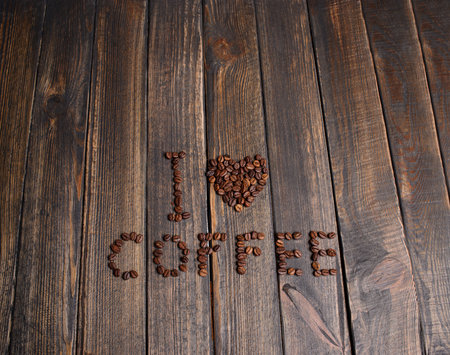 word I" love coffee" made from coffee beans on wooden backgroundの写真素材