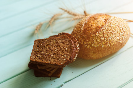traditional bread loaf with spikelets on a lime wooden boardの写真素材