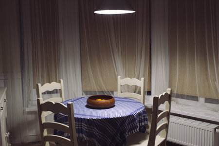 kitchen table with tablecloth and chairsの写真素材