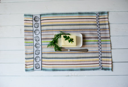 piece of butter with knife on a wooden deskの写真素材