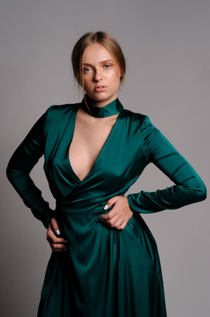 Gorgeous woman in green dress. Studio picture, grey backgroundの写真素材