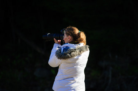 photographer with camera outdoor making landscape pictureの写真素材
