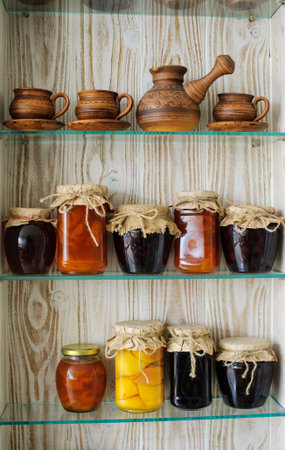 Jars with jam on the kitchen shelvesの写真素材