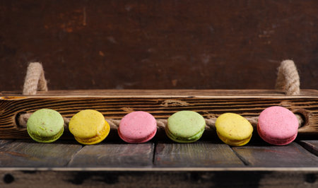 Sweet and colourful french macaroons or macaron on the wooden backgroundの写真素材
