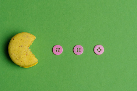 Sweet and colourful french macaroons or macaron on green background