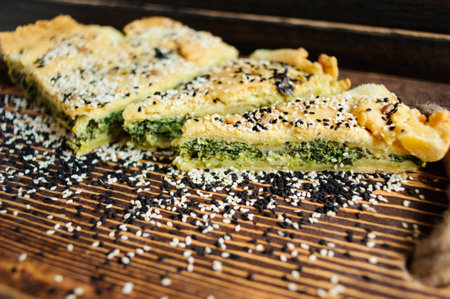 Homemade spinach french pie quiche lorraine on a white wooden boardの写真素材