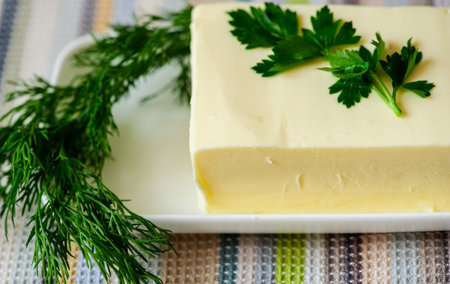 piece of butter with knife on a deskの写真素材