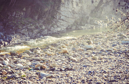 Rocky coast of the river. Landscape of countryside river. Big stones on shore of the riverの写真素材