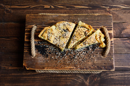 Homemade spinach french pie quiche lorraine on a white wooden boardの写真素材