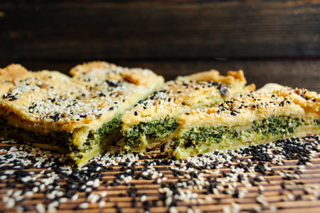 Homemade spinach french pie quiche lorraine on a white wooden boardの写真素材