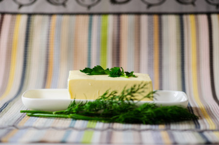 piece of butter with knife on a deskの写真素材