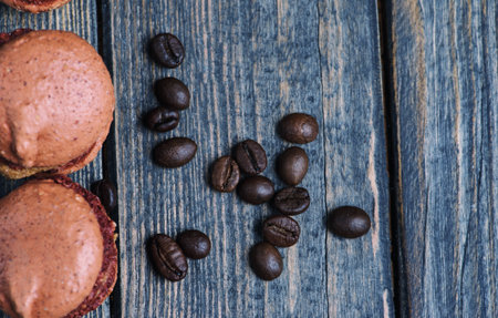 Sweet and colourful french macaroons with coffee beans on the wooden backgroundの写真素材
