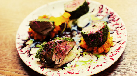 Beautiful served food on plates in restaurantの写真素材