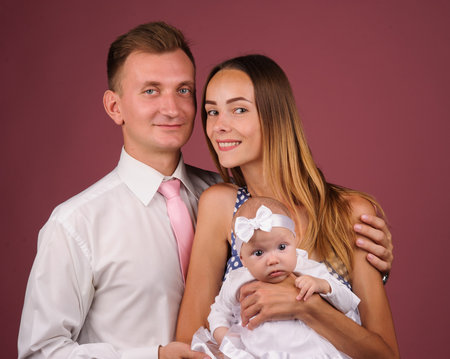 happy parents with newborn baby on a handsの写真素材