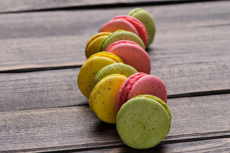 Sweet and colourful french macaroons or macaron on the wooden backgroundの写真素材