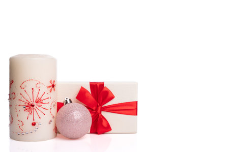 Christmas set on a white background. Candle, gift box with red ribbon and toy.の写真素材