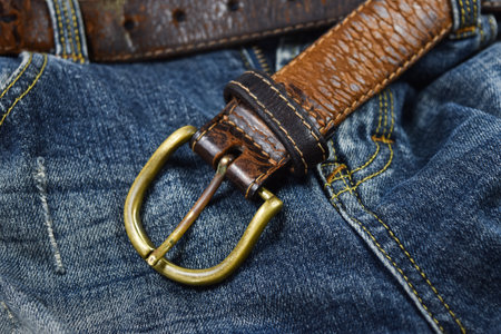 leather belt close-up put on Blue jeansの写真素材