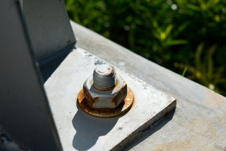 Rusty screw metal nut with bolts on steel beam backgroundの写真素材