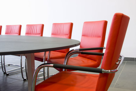 Red leather armchairs in a meeting roomの写真素材