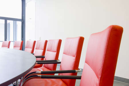 Red leather chairs in a conference roomの写真素材