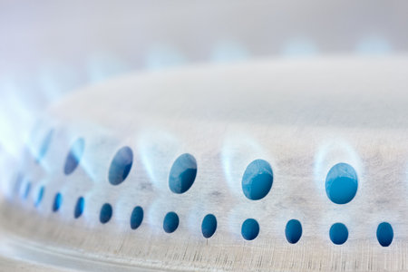 Blue flames of a gas stove taken by dayの写真素材