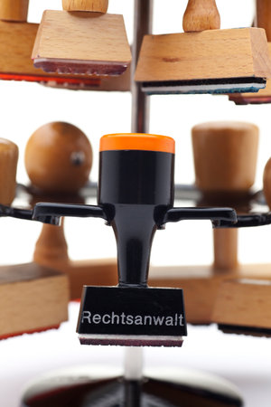 Close-up of  a stamp holder with many stamps - one of them with the german word for advocate, lawyer or attorneyの写真素材