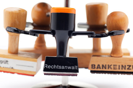 Close-up of a stamp holder with many stamps - one of them with the german word for advocate, lawyer...