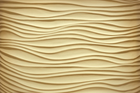 Luxury khaki brown art template in form of sandy seaside shore dune bend shape in plain artistic style. Pastel ocher color solid gesso emboss fond design. Closeup view with ecru cream space for textの写真素材