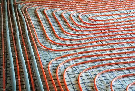 Modern manual laying of tuning water hydronic gas firing conduit supply on metal mesh insulation...