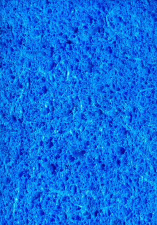 Dark cyan color artificial synthetic cushion polyurethane styrofoam scour swab wipe design for soft wet soak absorb water use or carwash scourer. Detail spongy closeup micro view and space for textの写真素材