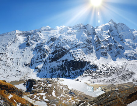 Beautiful great north Alpen trip mountainside vista panorama of plateau. Light clouds on bright blue heaven above tall crag. Rural scenic top view with space for text. freeze pond in rocky ravineの写真素材
