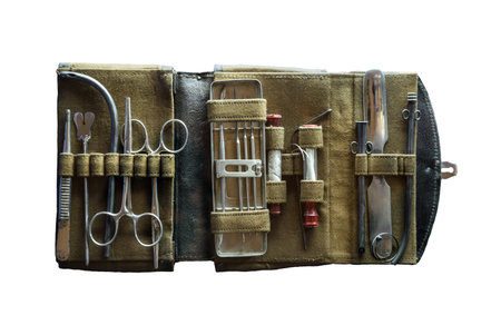Aged nurse physician accessory in container on blue background. Aseptic hemostat, hypodermic tube, extraction tenaculum, steel hand lancet, tooth probe device, iron forcipes. Closeup obsolete objectの写真素材