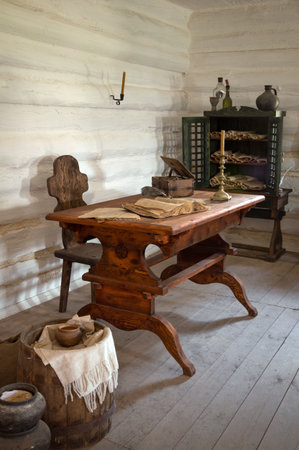 Hortica, Zaporozhye, 2015 JUNE. Zaporizhian Sich Cossack Museum. Inside log cabinet of Monk scribe of St Scripture, military clerk. Scrolls orders, declarations and law in wooden bookcase. Indoor viewの写真素材
