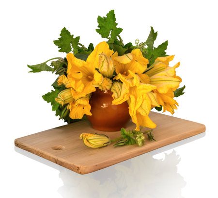 Still Life in potpourri style. Magnificent bouquet of huge orange flowers pumpkin with leaves and buds in ancient clay pot on wooden chopping board isolated on white background with clipping maskの写真素材