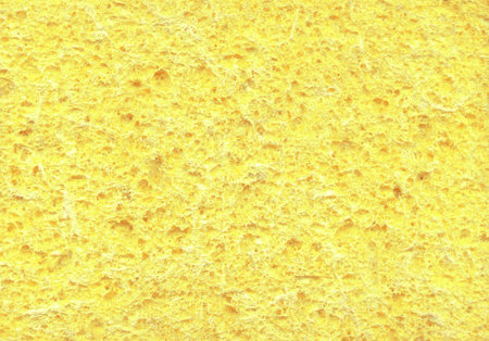 New light golden color artificial synthetic cushion polyurethane styrofoam swab wiper design for soft wet soak absorb water home use or carwash scourer. Detail spongy closeup view with space for textの写真素材
