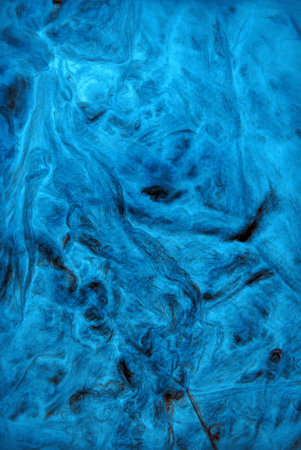 Modern artificial synthetic celeste toned grained wrinkled form relief. Wavy flow crumpled whirl structure. Closeup top detail macro view with space for text on shiny cerulean fondの写真素材