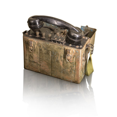 Vintage wartime period used soldier talk field case portable rusty shortwave node data demodulator box with plastic tube isolated on light backdrop with clipping path. View closeup with space for textの写真素材