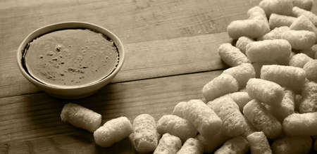 Close up top view dry golden red jam crisp fluffy air honey puffcorn finger heap group pile stack light wood board plate text space. closeup fat roast french diet potato onion cheese spice flavor tastの写真素材