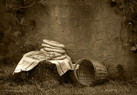 Holy fresh raw simple rural box barley pita cake bakery Lord pray bless retro age Israel sign story. Closeup view jew towel cloth catholic supper still life outdoor stone garden wall field text spaceの写真素材