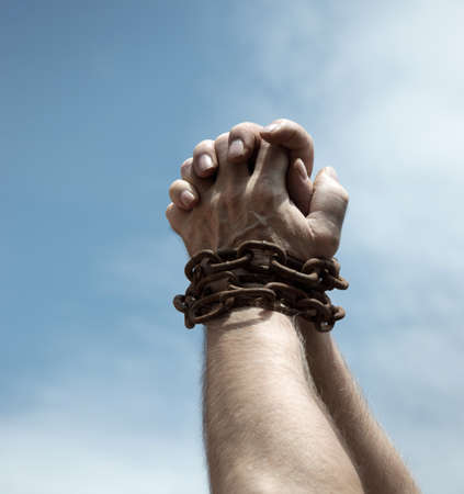 Old vintage sad despair fear pressure stress guy prayer hope life sun light blue text space. Closeup restrict kidnap limit hold fist wrist bind rope restrain abuse sign close up hopeless caught bodyの写真素材